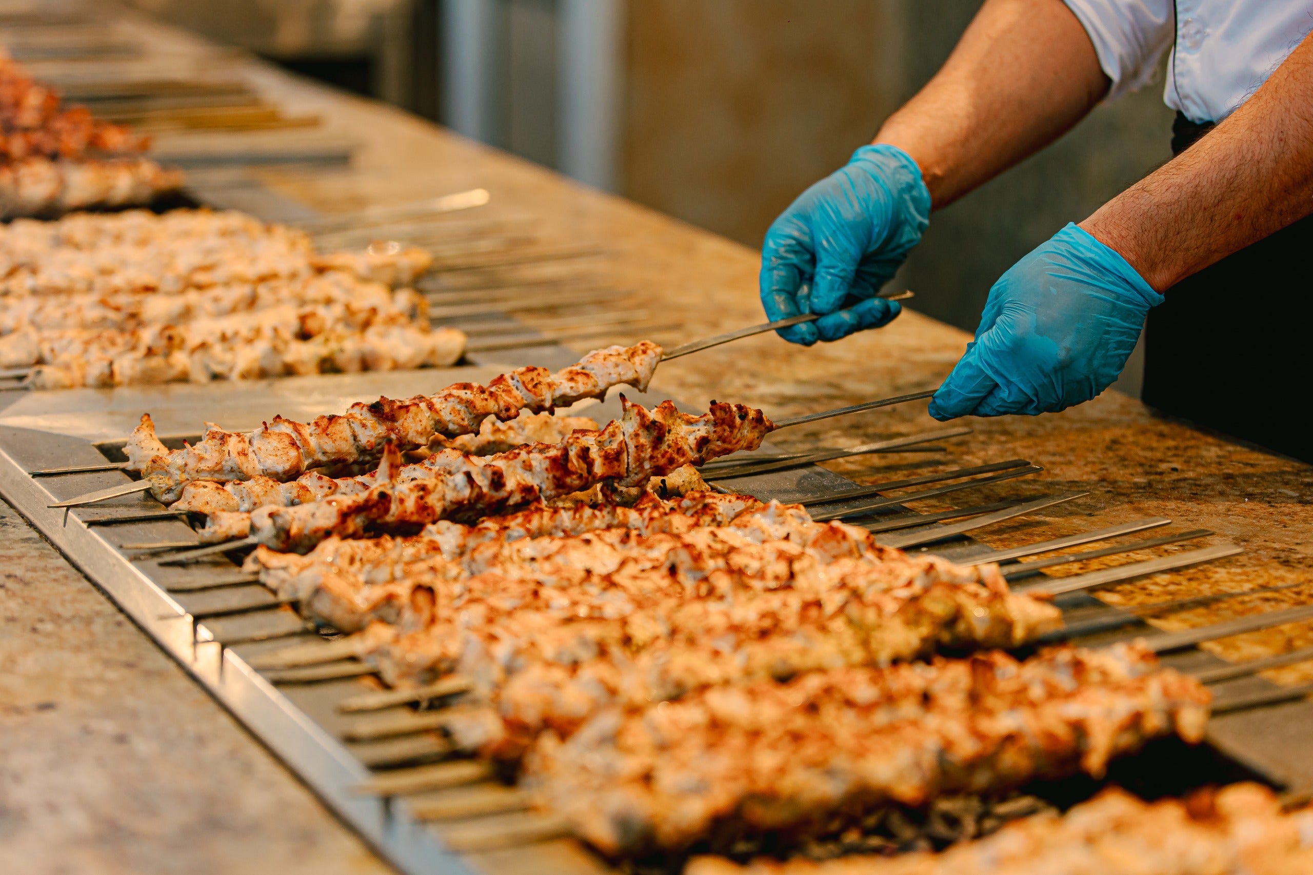 Chef preparing BBQ dishes at the desert safari camp in Dubai